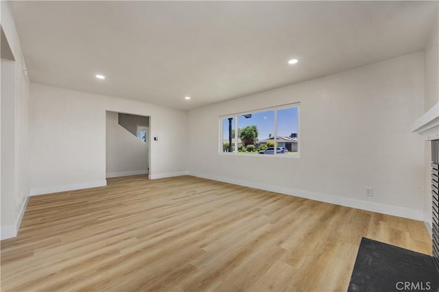 3009 Delburn St, Bakersfield, CA 93304 - unfurnished living room with recessed lighting, light wood-style floors, and a fireplace