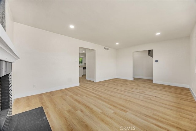 3009 Delburn St, Bakersfield, CA 93304 - unfurnished living room with a fireplace, light wood-type flooring, and recessed lighting