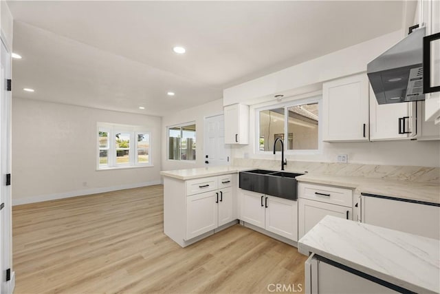 3009 Delburn St, Bakersfield, CA 93304 - kitchen featuring ventilation hood, light wood finished floors, white cabinetry, light stone countertops, and recessed lighting