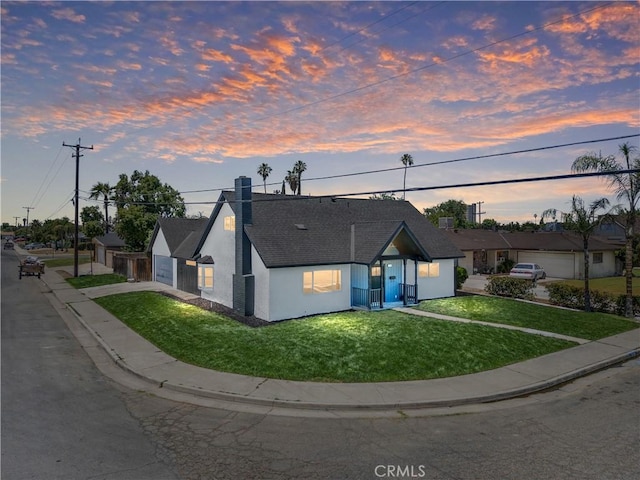 3009 Delburn St, Bakersfield, CA 93304 - view of front facade featuring a front yard, roof with shingles, stucco siding, and a chimney