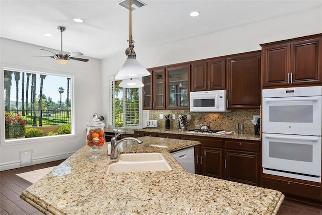 29530 Winding Brook Dr, Menifee, CA 92584 - kitchen with white appliances, tasteful backsplash, a ceiling fan, hanging light fixtures, and dark brown cabinets