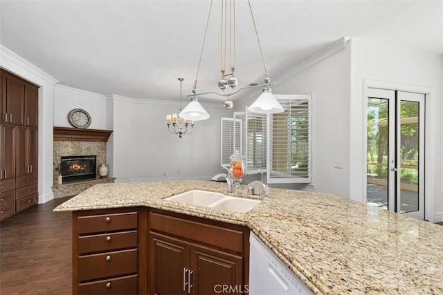 29530 Winding Brook Dr, Menifee, CA 92584 - kitchen featuring white dishwasher, a fireplace, crown molding, light stone countertops, and dark wood finished floors