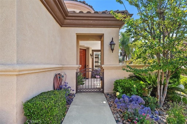 29530 Winding Brook Dr, Menifee, CA 92584 - view of exterior entry featuring stucco siding and a gate