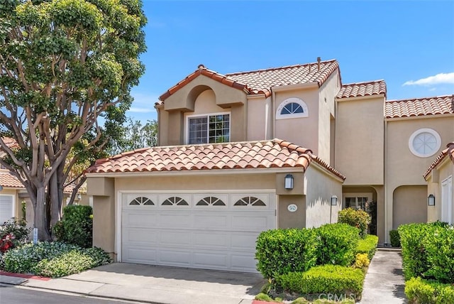 50 Niguel Pointe Dr Unit 118, Laguna Niguel, CA 92677 - mediterranean / spanish-style home with a tiled roof, concrete driveway, stucco siding, and a garage