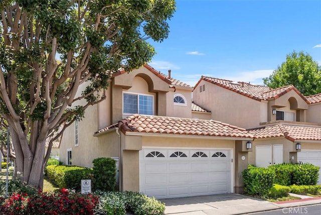 50 Niguel Pointe Dr Unit 118, Laguna Niguel, CA 92677 - mediterranean / spanish home featuring stucco siding, driveway, a garage, and a tile roof