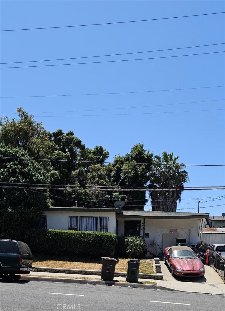 1108 W 120th St, Los Angeles, CA 90044 - view of front facade featuring concrete driveway and an attached carport