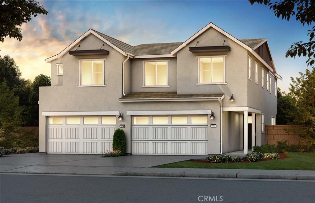 131 Moonflower Rd, Rancho Mission Viejo, CA 92694 - townhome / multi-family property featuring a garage, driveway, and stucco siding