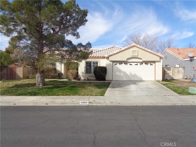 3407 Amber St, Rosamond, CA 93560 - view of front of property featuring stucco siding, an attached garage, concrete driveway, and a tile roof