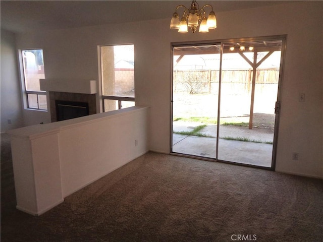 3407 Amber St, Rosamond, CA 93560 - unfurnished dining area with a fireplace, a chandelier, and carpet