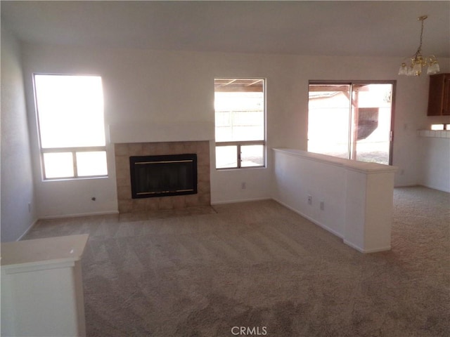 3407 Amber St, Rosamond, CA 93560 - unfurnished living room featuring carpet, a chandelier, and a tile fireplace