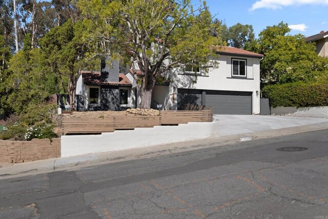 10594 Rookwood Dr, San Diego, CA 92131 - view of front of home with a garage, stucco siding, concrete driveway, and a tiled roof
