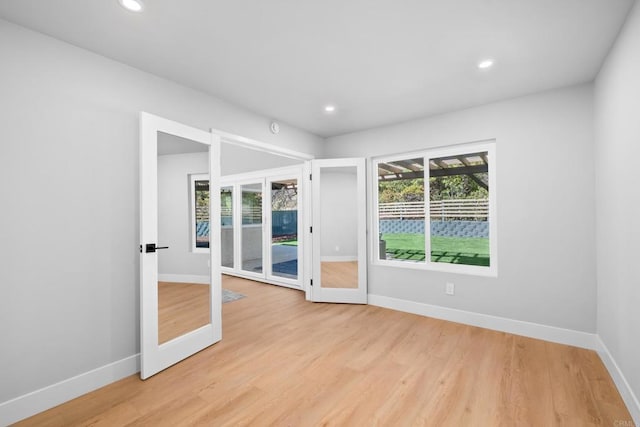 10594 Rookwood Dr, San Diego, CA 92131 - spare room featuring french doors, light wood finished floors, and recessed lighting