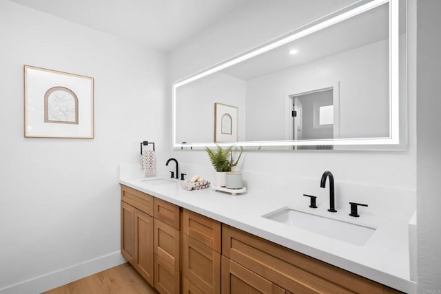 10594 Rookwood Dr, San Diego, CA 92131 - full bathroom featuring double vanity, wood finished floors, and recessed lighting