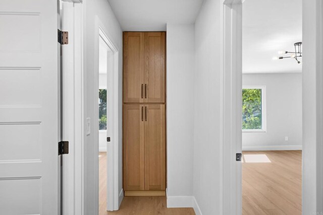 10594 Rookwood Dr, San Diego, CA 92131 - hall featuring light wood-style floors and a chandelier