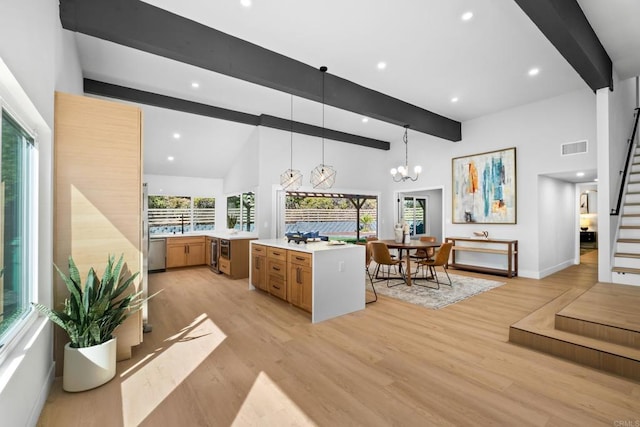 10594 Rookwood Dr, San Diego, CA 92131 - kitchen with beam ceiling, stainless steel dishwasher, brown cabinetry, light countertops, and light wood-style flooring