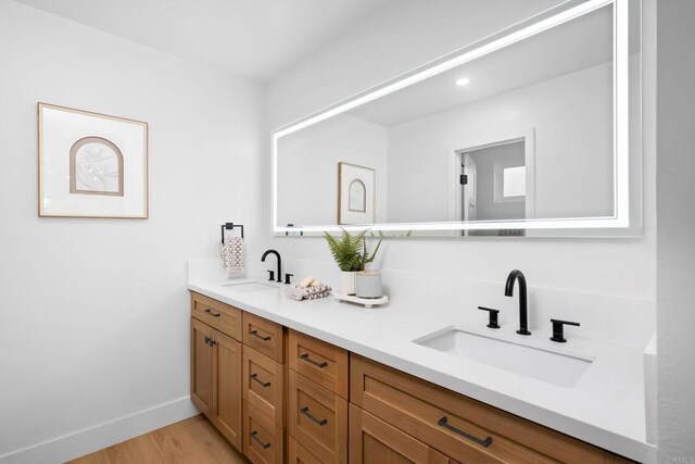 10594 Rookwood Dr, San Diego, CA 92131 - bathroom featuring double vanity and wood finished floors