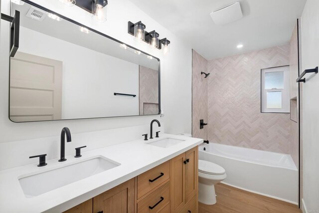 10594 Rookwood Dr, San Diego, CA 92131 - bathroom featuring double vanity, wood finished floors, and shower / tub combination
