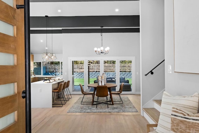 10594 Rookwood Dr, San Diego, CA 92131 - dining space featuring a chandelier, wood finished floors, stairs, and a high ceiling