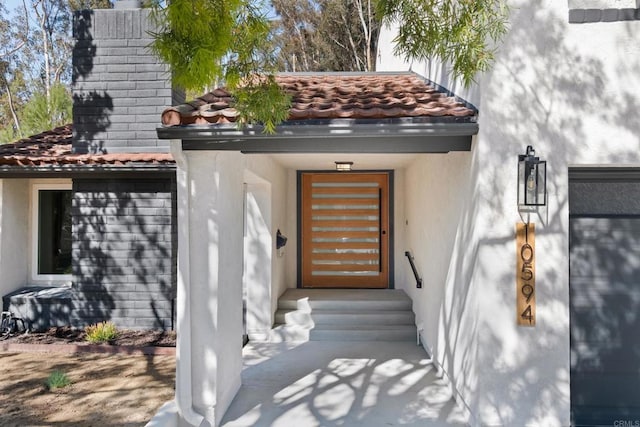 10594 Rookwood Dr, San Diego, CA 92131 - view of exterior entry with a tiled roof and stucco siding