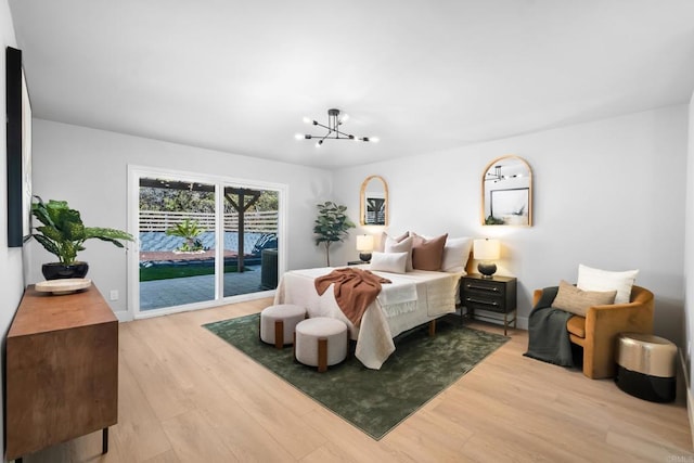 10594 Rookwood Dr, San Diego, CA 92131 - bedroom featuring access to outside, light wood-type flooring, and a chandelier