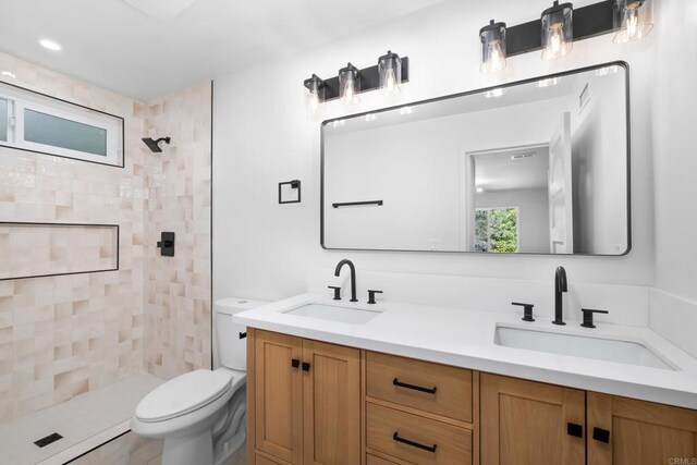 10594 Rookwood Dr, San Diego, CA 92131 - bathroom featuring double vanity and a tile shower