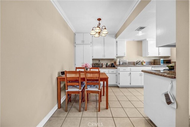 1821 Pepper St Unit 3, Alhambra, CA 91801 - kitchen featuring crown molding, white cabinets, stainless steel microwave, hanging light fixtures, and light tile patterned flooring