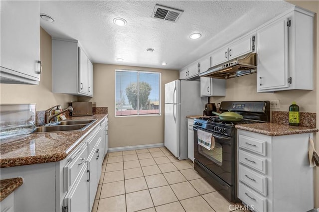 1821 Pepper St Unit 3, Alhambra, CA 91801 - kitchen featuring black range with gas stovetop, under cabinet range hood, a textured ceiling, freestanding refrigerator, and white cabinets