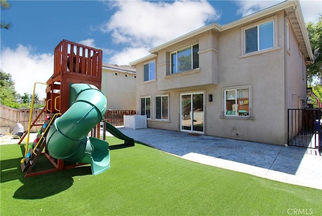 11961 Limestone Ct, Yucaipa, CA 92399 - rear view of house with stucco siding, a playground, and a patio area