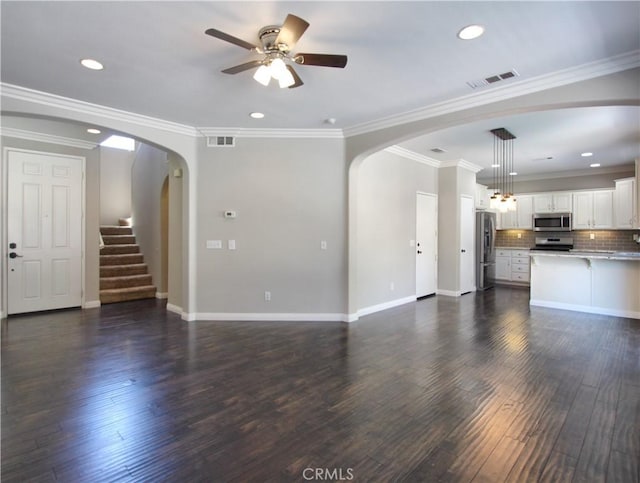 11961 Limestone Ct, Yucaipa, CA 92399 - unfurnished living room with ceiling fan, recessed lighting, dark wood-type flooring, arched walkways, and crown molding