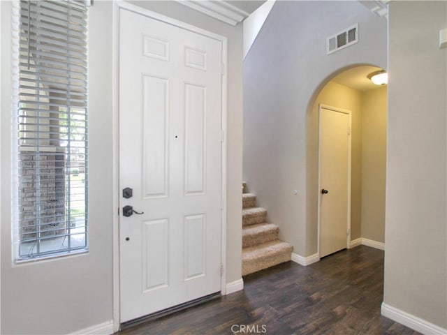 11961 Limestone Ct, Yucaipa, CA 92399 - entrance foyer with arched walkways, dark wood-style floors, and stairway