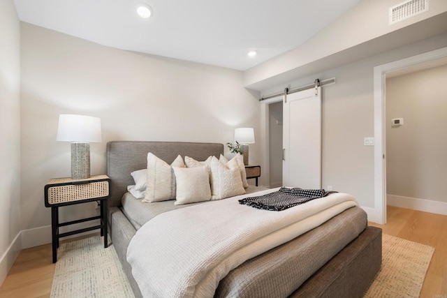 3584 Garfield St, Carlsbad, CA 92008 - bedroom featuring a barn door, light wood-type flooring, and recessed lighting
