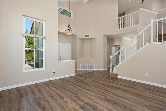 943 Masters Dr, Oceanside, CA 92057 - unfurnished living room featuring stairs, wood finished floors, and a high ceiling