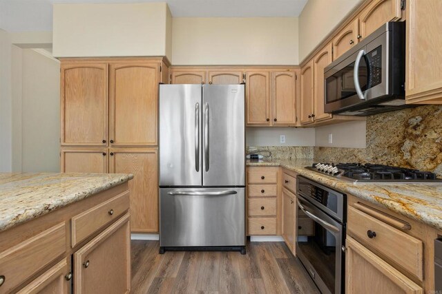 943 Masters Dr, Oceanside, CA 92057 - kitchen with appliances with stainless steel finishes, dark wood-type flooring, light stone countertops, light brown cabinetry, and tasteful backsplash