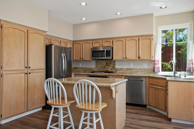 943 Masters Dr, Oceanside, CA 92057 - kitchen featuring stainless steel appliances, light brown cabinetry, a breakfast bar, dark wood-style flooring, and recessed lighting