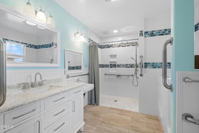2524 Monaco Dr, Oxnard, CA 93035 - bathroom featuring tiled shower, vanity, wood finished floors, and recessed lighting