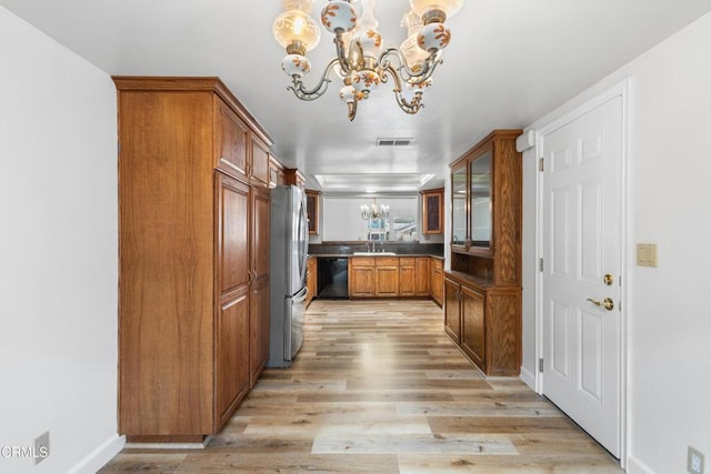 2524 Monaco Dr, Oxnard, CA 93035 - kitchen featuring a chandelier, freestanding refrigerator, brown cabinetry, and dishwasher