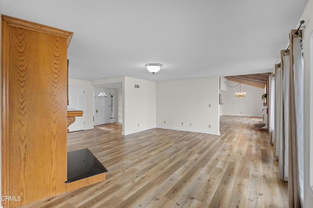 2524 Monaco Dr, Oxnard, CA 93035 - unfurnished living room with a chandelier and light wood-style flooring