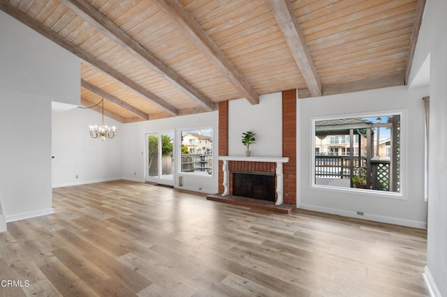 2524 Monaco Dr, Oxnard, CA 93035 - unfurnished living room featuring a chandelier, a fireplace, plenty of natural light, light wood-style floors, and a wooden ceiling with exposed beams