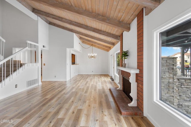 2524 Monaco Dr, Oxnard, CA 93035 - unfurnished living room with stairs, a chandelier, healthy amount of natural light, light wood finished floors, and a wood ceiling with exposed beams