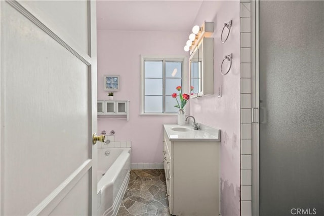 2505 N Keystone St, Burbank, CA 91504 - bathroom with vanity, a bath, and stone finish floors