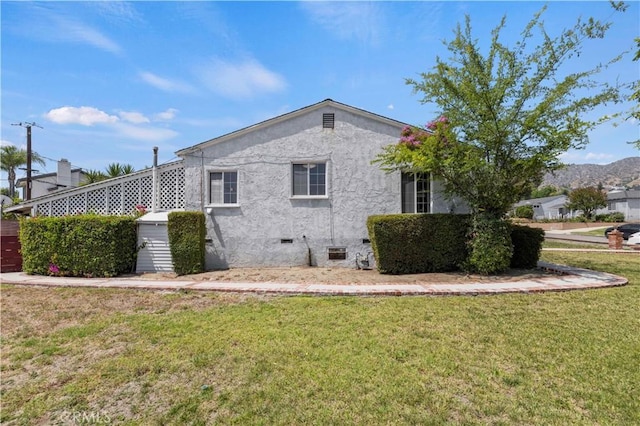 2505 N Keystone St, Burbank, CA 91504 - view of home's exterior featuring stucco siding, a yard, and crawl space