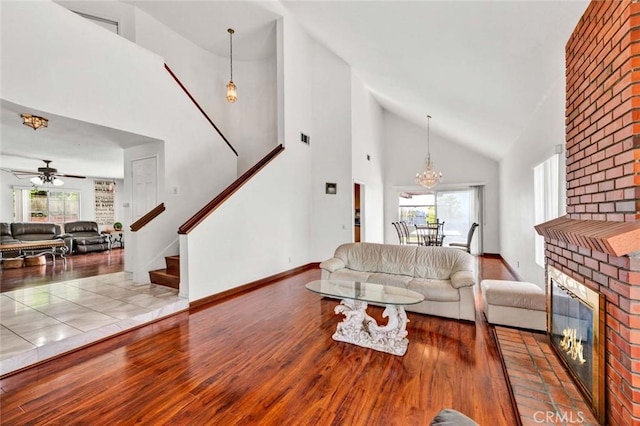 6322 E E W View Dr, Orange, CA 92869 - living room featuring wood finished floors, stairs, healthy amount of natural light, and high vaulted ceiling