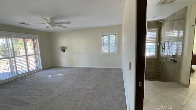 25105 Via Von Batsch, Moreno Valley, CA 92557 - unfurnished room with plenty of natural light, ceiling fan, light carpet, and light tile patterned floors