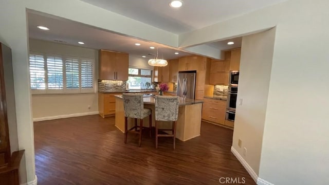 25105 Via Von Batsch, Moreno Valley, CA 92557 - kitchen with appliances with stainless steel finishes, dark wood finished floors, decorative backsplash, recessed lighting, and a kitchen island