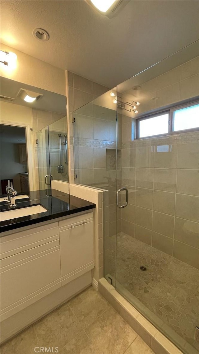 25105 Via Von Batsch, Moreno Valley, CA 92557 - bathroom with tile patterned floors, vanity, and a shower stall