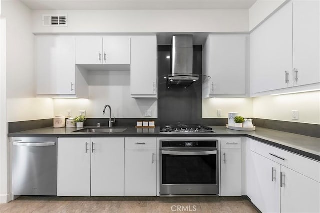2526 Nolita, Irvine, CA 92612 - kitchen with appliances with stainless steel finishes, wall chimney range hood, white cabinetry, and dark countertops