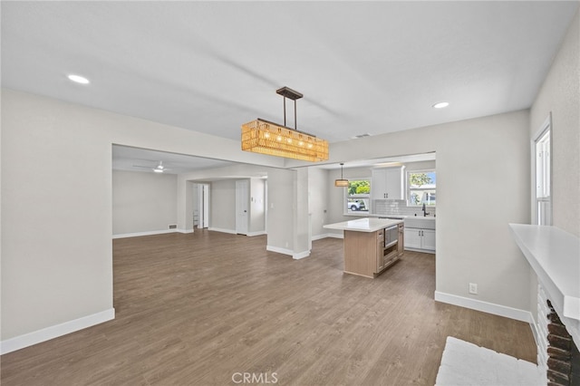 1514 E Palm Ave, Orange, CA 92866 - kitchen featuring light countertops, a center island, open floor plan, dark wood finished floors, and recessed lighting