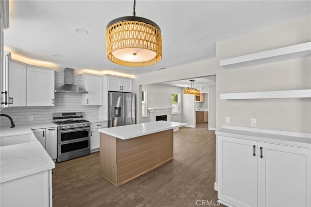 1514 E Palm Ave, Orange, CA 92866 - kitchen with appliances with stainless steel finishes, wall chimney range hood, tasteful backsplash, a kitchen island, and hanging light fixtures