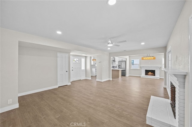 1514 E Palm Ave, Orange, CA 92866 - unfurnished living room with a fireplace, ceiling fan, light wood-style flooring, and recessed lighting