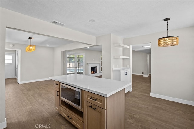 1514 E Palm Ave, Orange, CA 92866 - kitchen featuring stainless steel microwave, open floor plan, dark wood finished floors, pendant lighting, and a textured ceiling